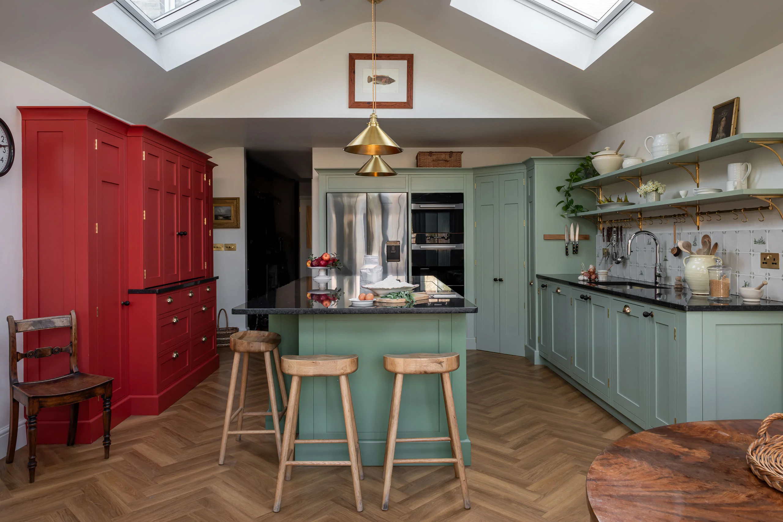 Green Shaker kitchen at Grantchester Revival in Cambridge, Little Greene Boringdon Green cabinetry, a Farrow and Ball Calke Green island and a red breakfront cupboard